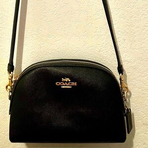 “NWOT” Authentic COACH. It is Black (small pebbled leather) with gold hardware.